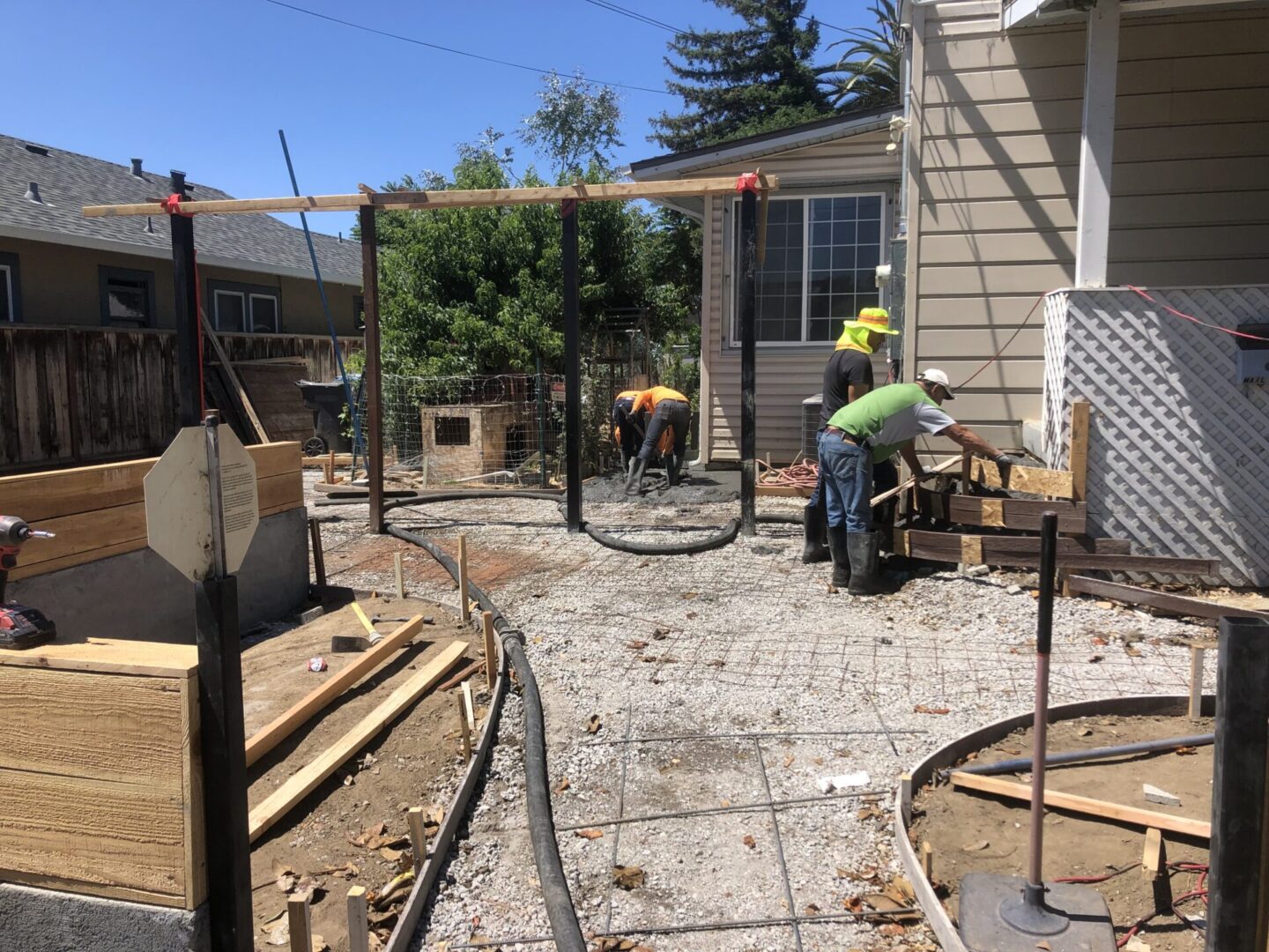 A man working on the ground in front of a house.