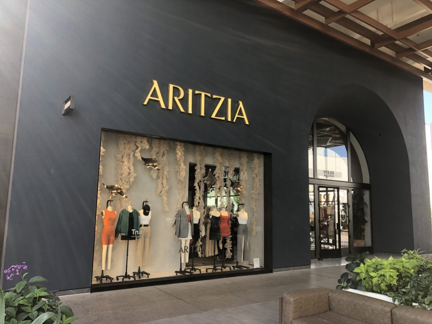 A store front with a large window and a sign.