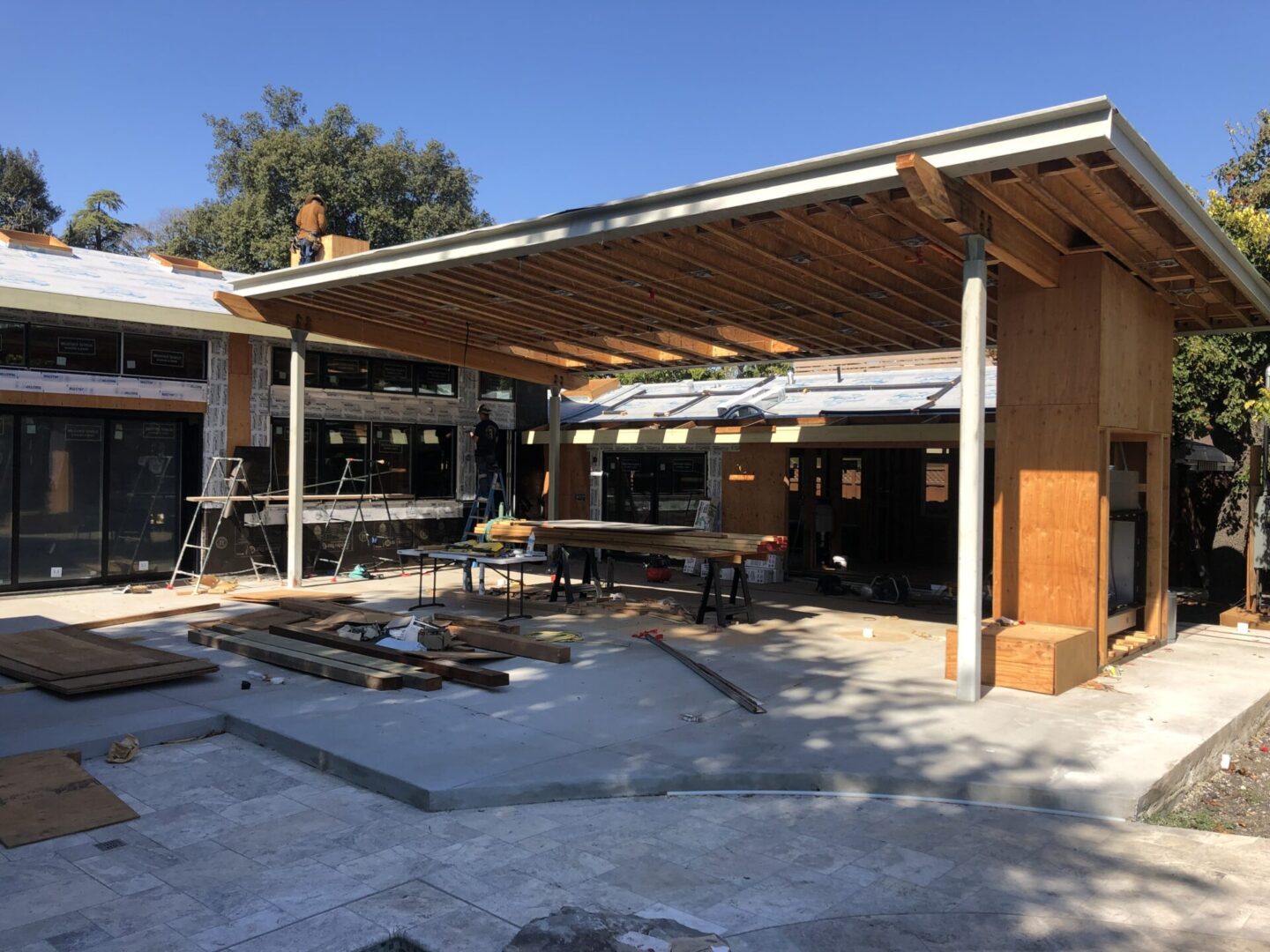 A covered patio with tables and chairs under an awning.