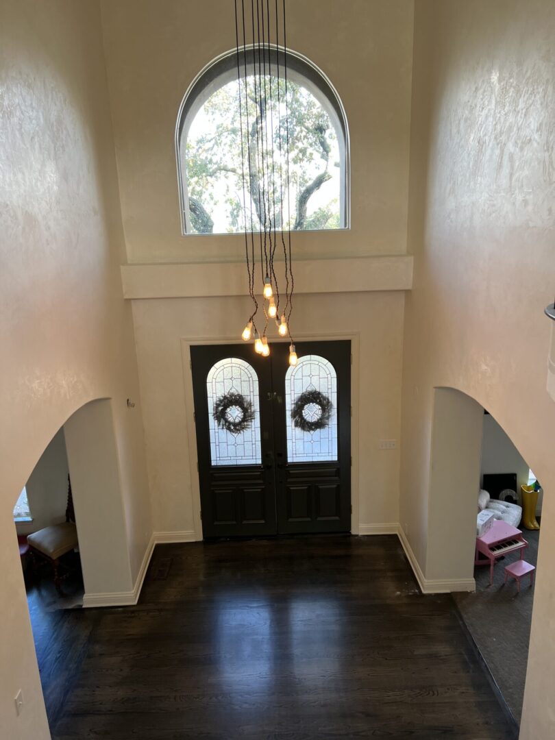 A doorway with two windows and lights in the center.