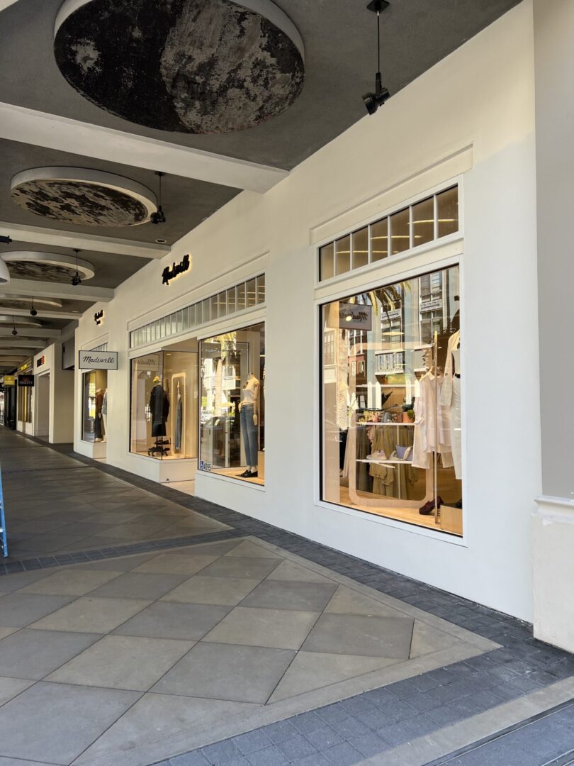 A store front with many windows and people in it.