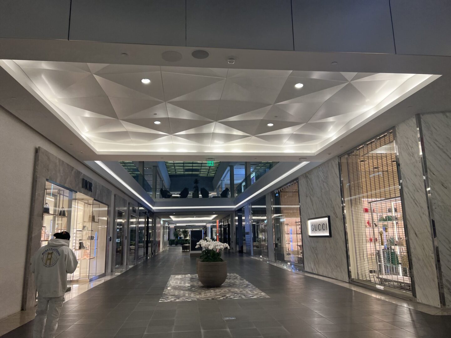 A large hallway with many lights on the ceiling.