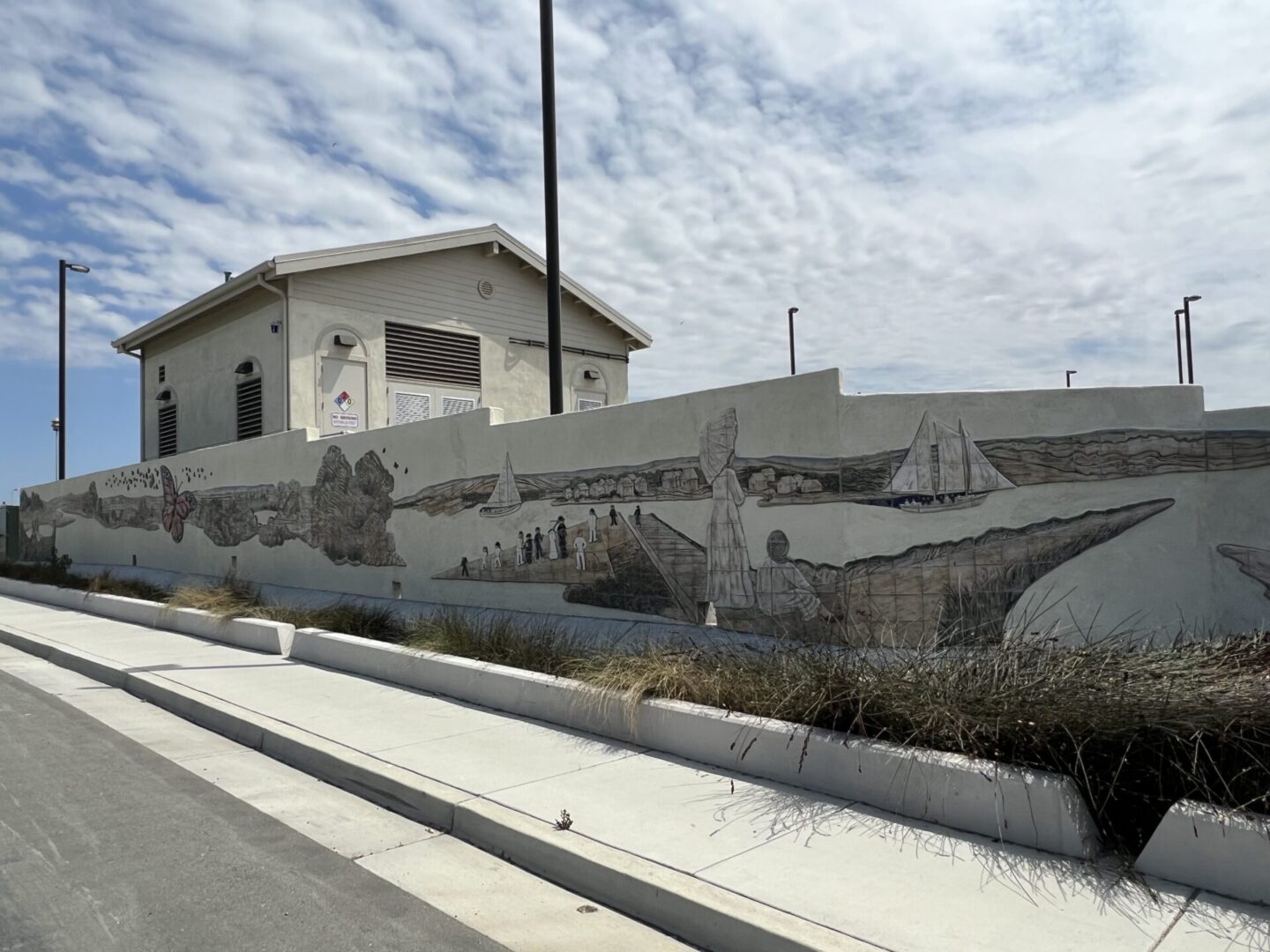 A mural of boats on the side of a wall.