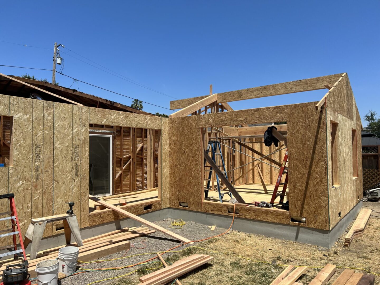 A house being built with wood framing and construction materials.