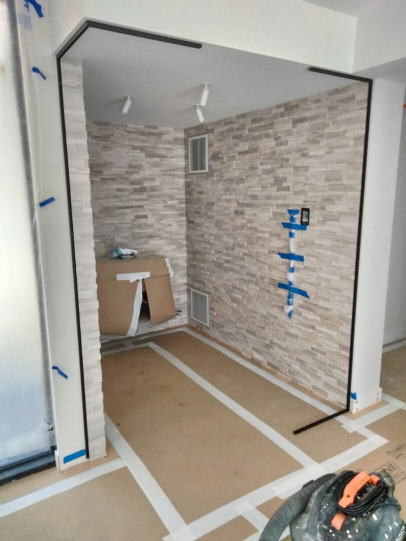 A bathroom with a shower and tiled walls.